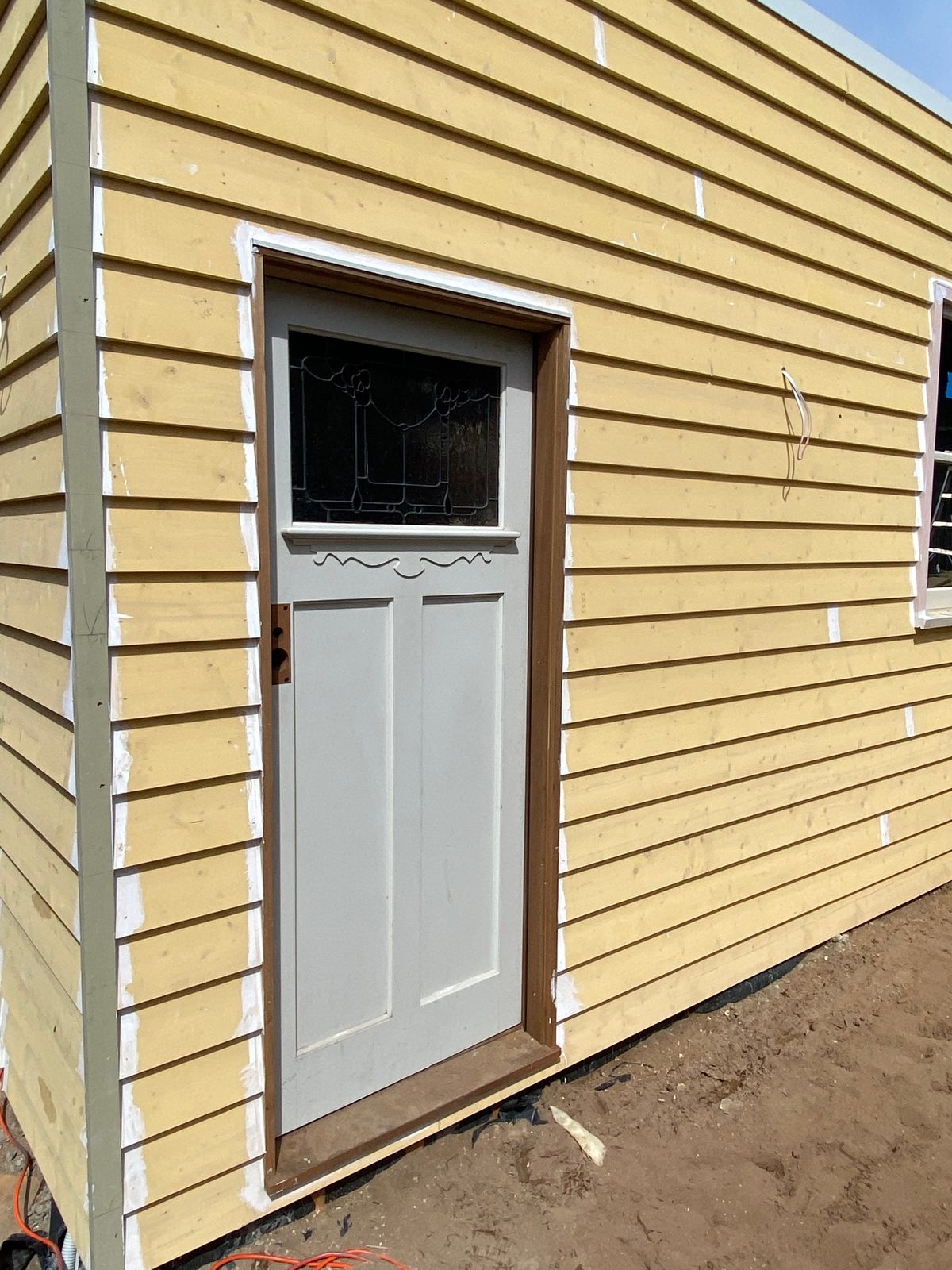 Halifax Street garage build, weatherboard cladding and personnel door